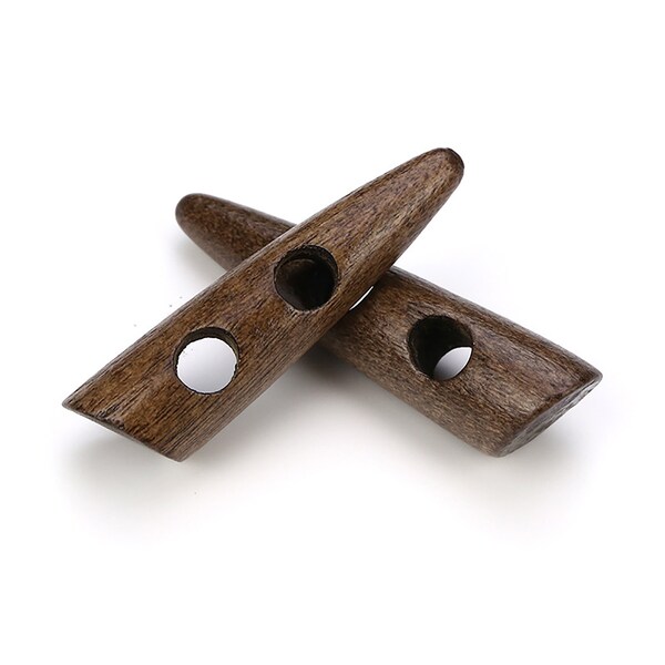 May include: Two brown wooden toggle buttons with two holes each. The buttons are shaped like a long, thin oval with a pointed end.