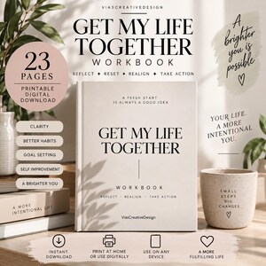 Op de afbeelding: Een Get My Life Together werkboek met een beige kaft en zwarte tekst. De kaft bevat de tekst A fresh start is always a good idea, Get My Life Together, en Reflect, Realign, Take Action. Een gespikkelde beige mok bevat de tekst Small steps big changes.