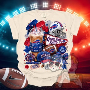 May include: A cream-colored t-shirt featuring a graphic print of a Buffalo Bills iced coffee, a football helmet, a pennant with the text Game Day Bills, a football, a blue cap, a pom-pom, a pencil, a ticket, a bow, and heart-shaped sunglasses.