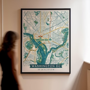 Peut inclure: Une carte murale encadrée de Washington DC présentant une palette de couleurs bleu sarcelle et jaune avec des réseaux de rues, des plans d'eau et des parcs. Le texte en bas indique WASHINGTON DC suivi des coordonnées 38° 54' N | 77° 2' W.