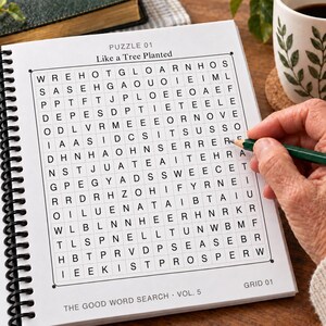 May include: A spiral-bound word search puzzle book titled The Good Word Search Vol. 5, featuring a grid labeled Puzzle 01 Like a Tree Planted. The page contains a square grid of letters with a green pencil pointing toward the letter E in the grid.