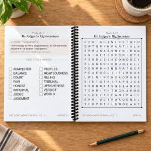 May include: A spiral-bound word search book open to Puzzle 01 titled He Judges in Righteousness. The left page lists words to find and a verse from Psalm 9:8. The right page features a grid of letters. A pencil lies on the surface below the book.