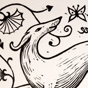 May include: Black and white line art illustration of a stylized dog with a butterfly and floral designs in the background.