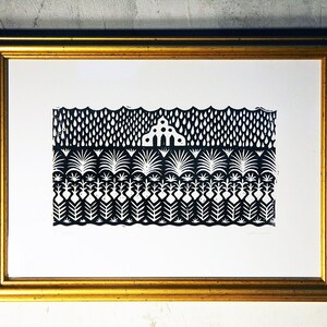 May include: Black and white print of a stylized landscape with a house in the middle. The print is framed in a gold frame.