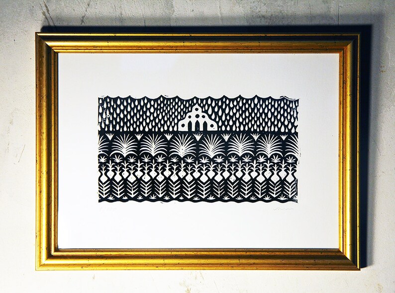 May include: Black and white print of a stylized landscape with a house in the middle. The print is framed in a gold frame.