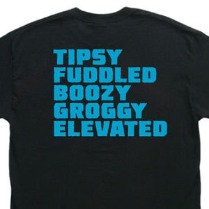 May include: Black t-shirt with the words "Tipsy", "Fuddled", "Boozy", "Groggy", and "Elevated" printed in blue.