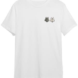 A white t-shirt with a small graphic design on the front, depicting two cartoon-like animal heads facing each other.
