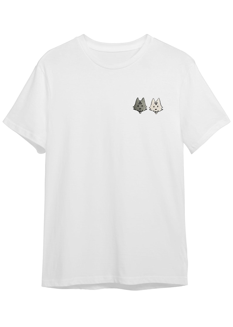 A white t-shirt with a small graphic design on the front, depicting two cartoon-like animal heads facing each other.