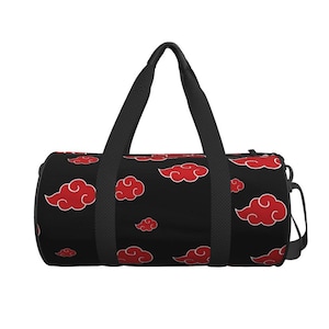 May include: A black cylindrical duffel bag featuring a repeating pattern of red stylized clouds with white outlines. The bag includes two black fabric handles that extend from the base to the top, a side zipper closure, and a black adjustable shoulder strap.