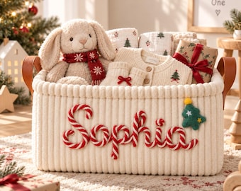 May include: A cream-coloured ribbed storage basket with brown leather handles, featuring the name Sophia embroidered in red and white candy cane-style lettering, accented with a small green felt Christmas tree appliqué.