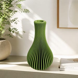 May include: A bright green vase with a vertical ribbed texture and a narrow neck. The vase has a rounded, bulbous body that tapers upwards to a circular opening, featuring a consistent pleated design throughout its entire exterior surface.