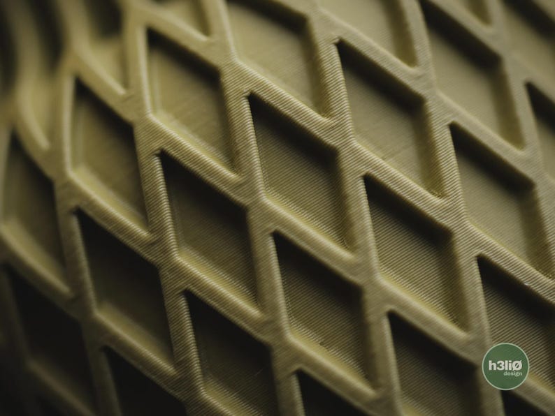 May include: A close-up view of a matte olive green object featuring a repeating diamond-shaped lattice pattern with visible 3D printed layer lines. A small circular logo in the bottom right corner displays the text h3li&oslash; design.