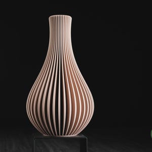 May include: A light peach-coloured vase with a vertical ribbed texture and a narrow neck that flares into a rounded base. The vase features a repeating pattern of thin, deep grooves along its entire exterior surface. The text h3li&oslash; design is visible.