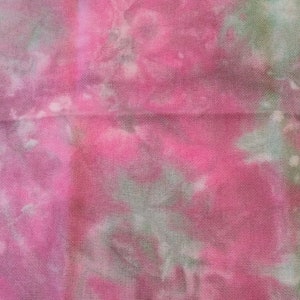 May include: A pink and green tie-dye fabric with a white background. The fabric has a subtle texture and is perfect for crafting projects. Fabrics by Bekki's Stitches.