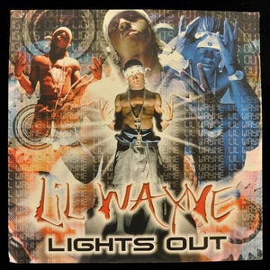 May include: A red, white, and blue album cover with the text "Lil Wayne" and "Lights Out" in large, bold letters. The cover features a collage of images of Lil Wayne, including a close-up of his face and a full-body shot of him in a white shirt and jeans.