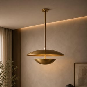 May include: A brass pendant light fixture featuring a large, shallow, downward-curving upper disc and a smaller, deeper, upward-curving lower bowl, both suspended from a central vertical rod attached to a circular ceiling mount.