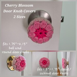 May include: Crochet door knob covers in a cherry blossom design with pink and light pink yarn. Text reads: Cherry Blossom Door Knob Covers 2 Sizes, fits 1.75"-2.15" bell and round door knobs, fits 1.5"-1.75" closet/cabinet door knobs.