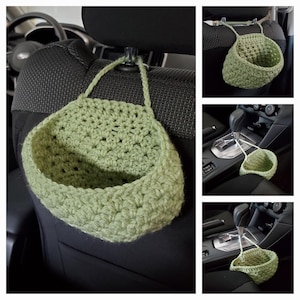 Op de afbeelding: Een saliegroene gehaakte hangmand met &eacute;&eacute;n handvat, ontworpen om aan de hoofdsteun of versnellingspook van een auto te hangen. De mand heeft een gestructureerd patroon met open steken en een afgerond opbergvak voor diverse kleine voorwerpen.