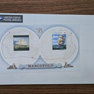 May include: A white envelope with two circular designs featuring stamps of sailing ships. The left stamp reads "85¢" and the right stamp reads "CANADA 46". The text "MARCOPOLO" is below the designs. The top left corner has the "UNITED STATES POSTAL SERVICE" logo.