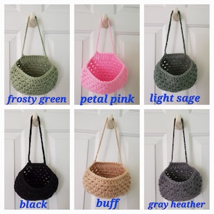 May include: Six crocheted hanging baskets in different colors: frosty green, petal pink, light sage, black, buff, and gray heather.