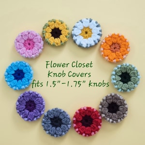 May include: A collection of ten circular, multi-colored crochet flower knob covers arranged in a circle. The text in the center reads: Flower Closet Knob Covers fits 1.5"-1.75" knobs. Each cover features a distinct color combination with a central core.