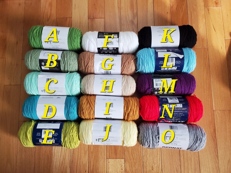 May include: Ten skeins of yarn in various colors, labeled A through J, and K through O. The yarn is arranged in two rows of five skeins each.