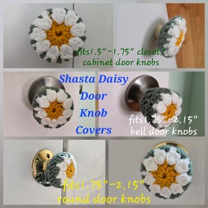 May include: Crocheted Shasta Daisy door knob covers featuring a yellow center, white petals, and a dark green border. Text indicates they fit 1.5-1.75 inch closet/cabinet knobs, 1.75-2.15 inch bell door knobs, and 1.75-2.15 inch round door knobs.