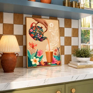 May include: A rectangular wall art print featuring a dark blue teapot with a vibrant floral pattern pouring a light brown liquid into a glass. The illustration includes stylized flowers and leaves in shades of pink, orange, and white against a beige background.