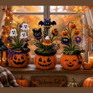 May include: Three crocheted pumpkin planters featuring Halloween-themed decorations. The left has white ghosts, the center a black cat and bat, and the right has orange pumpkins, a spider, and a web. Each pumpkin base has a stitched face.