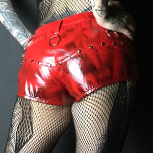 Red latex booty short pants with lacing and metal studs