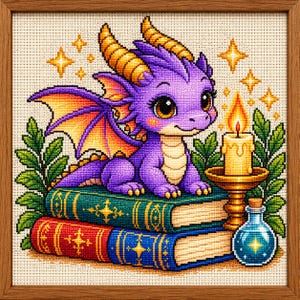 May include: A cross-stitch embroidery in a wooden frame depicting a purple dragon with yellow horns and wings sitting on two stacked books. Beside the dragon is a lit candle in a gold holder and a small blue potion bottle, surrounded by green leaves.