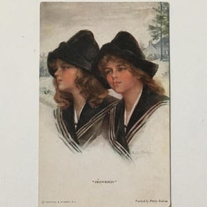 May include: Vintage postcard featuring a painting of two girls wearing black hats and sailor-style coats, standing in a snowy landscape. The text "Snowbirds" is printed below the image, and the artist's name "Philip Boileau" is printed below that.