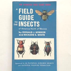 May include: A blue paperback book titled A Field Guide to the Insects of America North of Mexico by Donald J. Borror and Richard E. White. The cover features a large bee illustration at the top and three smaller beetle illustrations at the bottom.