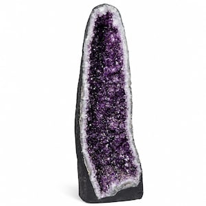 May include: A tall, vertical amethyst geode featuring a deep purple, crystalline interior cavity surrounded by a thick, dark gray, and textured rocky outer shell. The crystal formation tapers toward the top, showcasing natural jagged edges.