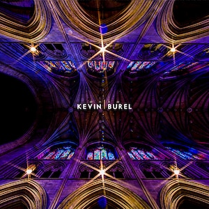 May include: An upward view of a cathedral ceiling with intricate architectural details. The image is dominated by shades of purple and gold, with stained glass windows and the text "KEVIN BUREL".