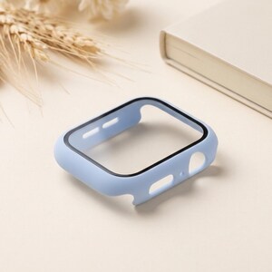 May include: A light blue protective watch case with a black screen frame. The rectangular accessory features precise cutouts for side buttons and the digital crown, designed to fit over the watch face to provide coverage and protection.