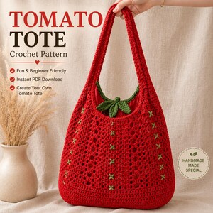 Puede incluir: Un bolso de ganchillo rojo con un detalle de hojas verdes en la abertura superior y pequeños detalles de punto de cruz verde en el cuerpo. El texto TOMATO TOTE Crochet Pattern es visible, junto con puntos para Fun & Beginner Friendly.