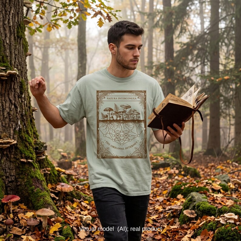 Biologist in an autumn forest wearing a sage green wood wide web mushroom t-shirt.
