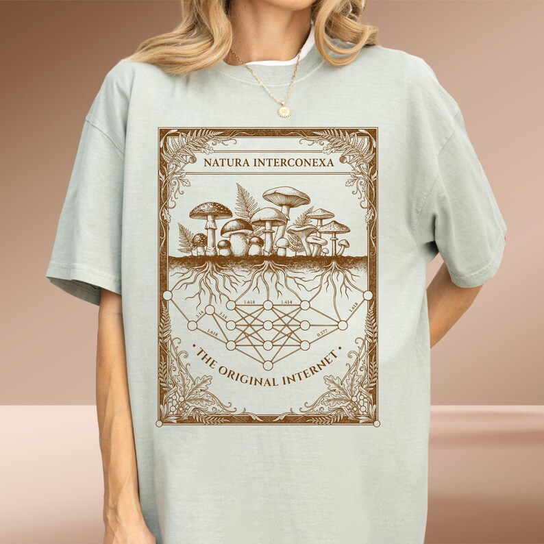 Sage green Comfort Colors t-shirt showing a vintage mushroom mycelium network and tech nodes graphic.