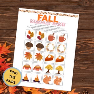 May include: A printable Fall Memory Game sheet featuring the title in orange and pink text, instructions, and a grid of twelve pairs of autumn-themed illustrations including leaves, mugs, acorns, wreaths, pie slices, sweaters, trees, fires, and squirrels.
