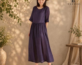 May include: A dark purple midi dress with a round neckline, short sleeves, and a gathered waistline. The dress features a simple, solid-coloured design with a relaxed fit. The brand name FATTOO is printed in the upper right corner of the image.