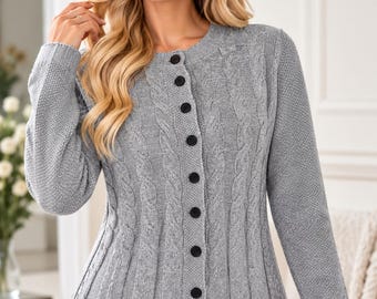 May include: A light grey long-sleeve knit cardigan featuring a vertical cable knit pattern, a round neckline, and a front button closure with seven black buttons. The garment includes the logo FATTOO DESIGN in the upper right corner.