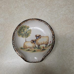 Ram/sheep motif ceramic scoop style spoon rest with hand sponged black and brown trim