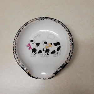 Cow motif ceramic scoop style spoon rest with hand sponged black and brown trim