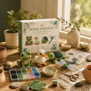 May include: A Pond Friends DIY beaded craft kit box featuring illustrations of a frog, duck, turtle, and dragonfly. The set includes finished beaded figures of these animals, a plastic organiser with colourful beads, a guide, and metal scissors.