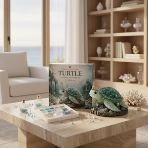 May include: A DIY bead kit box titled Mythical Ocean Series Turtle Guardian of the Depths, featuring a finished beaded turtle figurine with a crown, two small glass bottles filled with beads, and a white tray containing assorted coloured beads.
