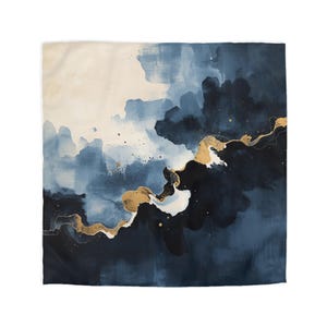 May include: A square wall art print featuring an abstract watercolour design with blended shades of navy blue, light blue, and cream. A prominent, flowing metallic gold vein cuts diagonally across the centre, accented by fine gold speckles.