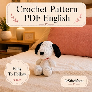 Könnte beinhalten: Ein weiß-schwarzes gehäkeltes Hunde-Spielzeug mit rotem Halsband. Das Bild enthält den Text Crochet Pattern PDF English, Easy To Follow und @StitchNest. Das Spielzeug hat einen runden Kopf, schwarze Schlappohren und eine kleine schwarze Nase.