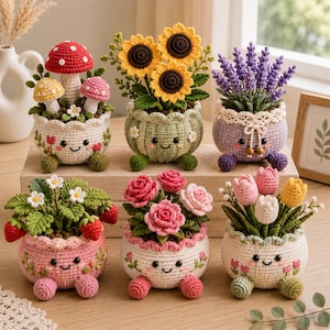 May include: Six crocheted potted plants with smiling faces on the pots. The plants include red and yellow mushrooms, sunflowers, lavender, strawberries, pink roses, and tulips. Each pot features a unique colour, embroidered details, and small feet.