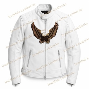 May include: A white leather jacket featuring a central graphic of a brown eagle with wings spread wide. The jacket has a mandarin collar with a snap closure, a full-length silver front zipper, two zippered side pockets, and quilted shoulder panels.